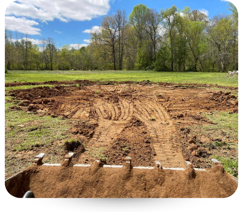 dirt plot in grass field. 